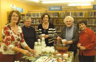 Festive friends serving cake and punch at the holidays