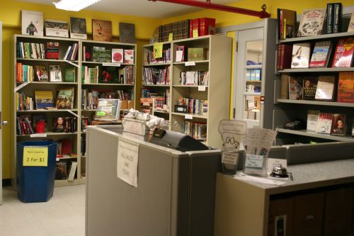 A view of the sales desk and several shelves of the Book Burrow used book store.