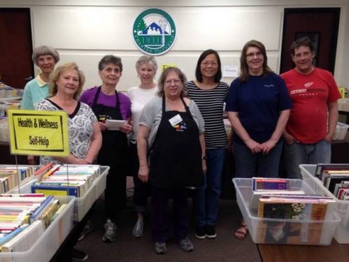 8 vounteers working a book sale