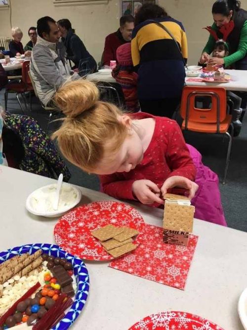 Family working on craft in library. 